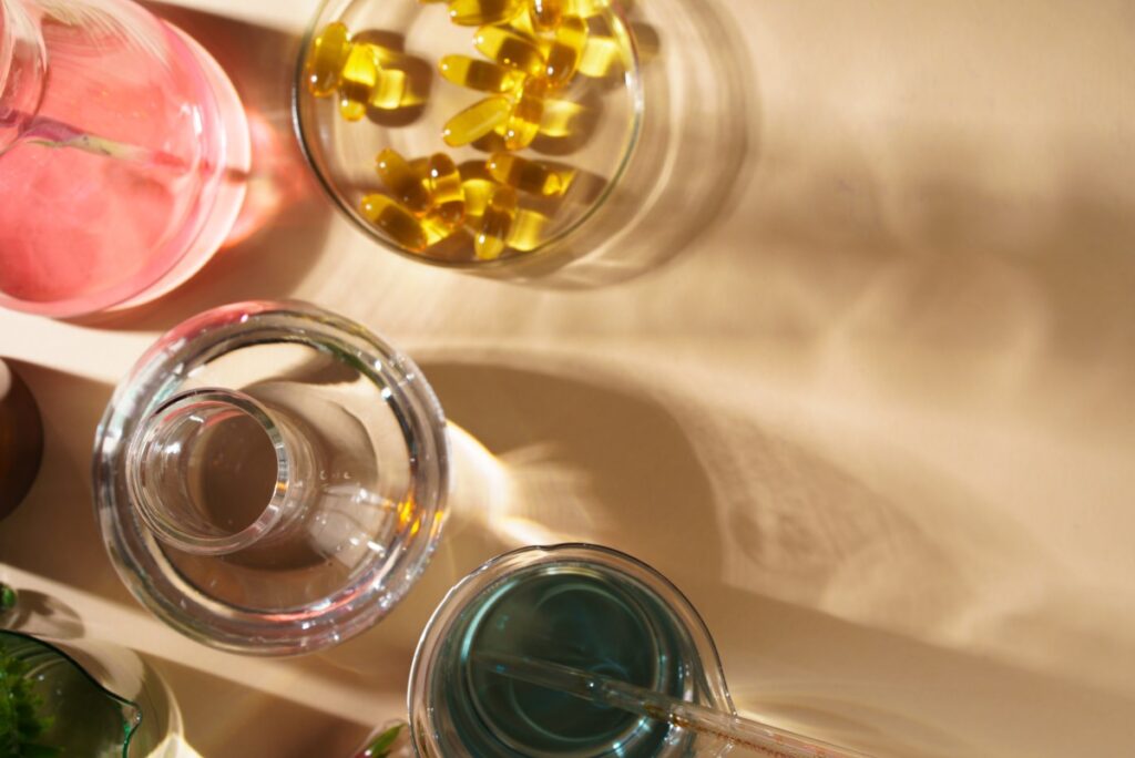 A bottle of halal collagen tablets next to a glass of water on a shelf. The collagen tablets are known for enhancing skin health and promoting a youthful appearance.