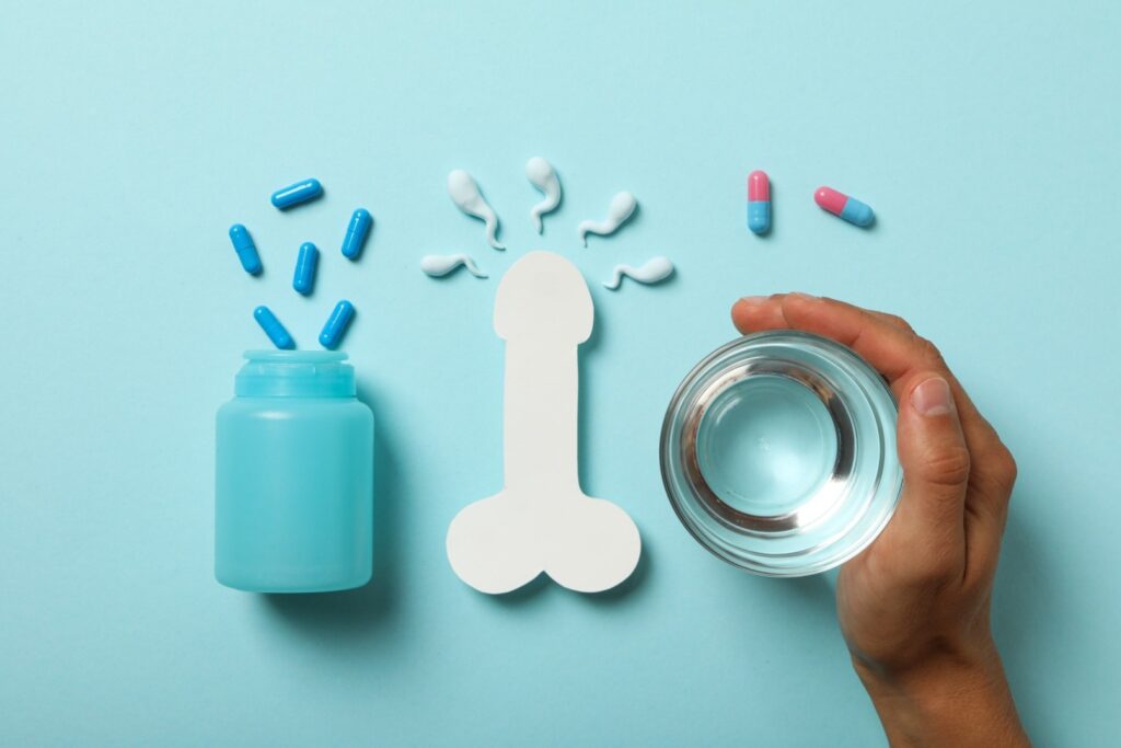 A bottle of male fertility supplements on the left side, with a man holding a glass of water beside it. These supplements are designed to support male fertility and enhance the chances of fatherhood.