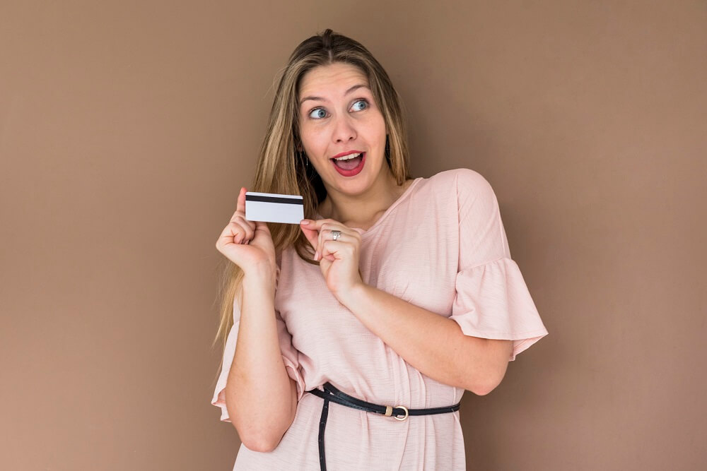 amazed-woman-dress-standing-with-credit-card