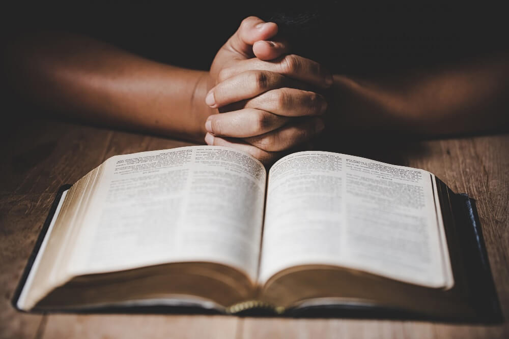 book and hands on table