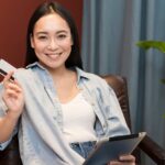 girl smiling and hold credit card