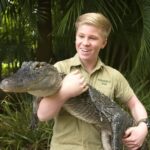 Robert Irwin hold a Crocodile