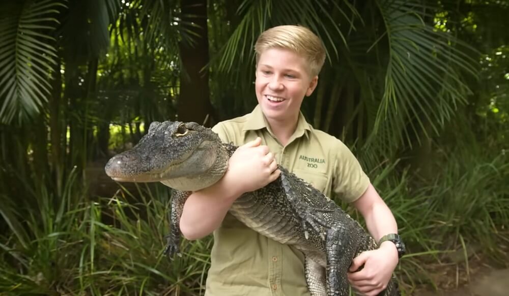 Robert Irwin hold a Crocodile